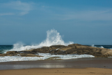 The big breaking waves during a strom at the beautiful summer sea shore background the blue sky and...