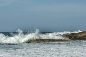 The big breaking waves during a strom at the beautiful summer sea shore background the blue sky and horizon