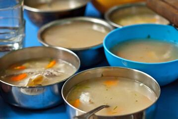 Fish soup is cooked on the fire. Ears in an iron bowl in nature.