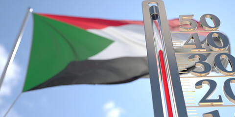 Thermometer shows high air temperature against blurred flag of Sudan. Hot weather forecast related 3D rendering