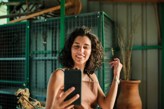 Woman taking a selfie in her small ceramic shop