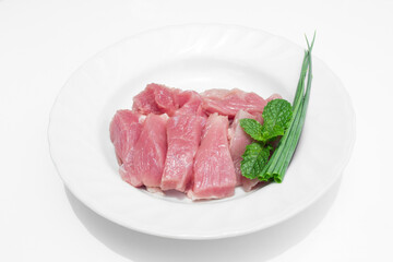 Fresh meat slides on a white plate.