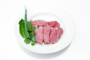 Fresh meat slides on a white plate.