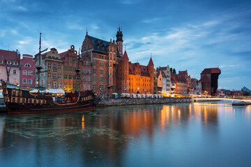 Amazing architecture of Gdansk old town at night with a new footbridge over the Motlawa River....