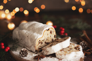 Traditional German Christmas cake - Cranberry Stollen, Christmas tree, ornaments, and candles.