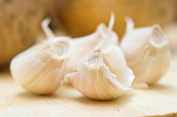 Garlic cloves and onions on a cutting board