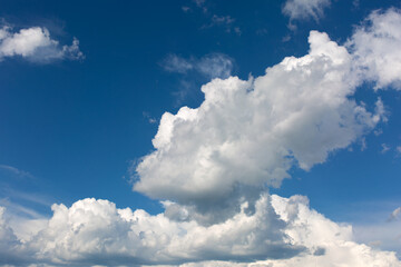 White clouds on blue sky background.