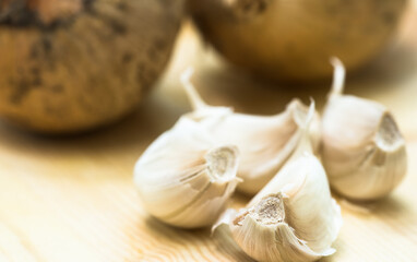 Garlic and onions on a wooden background