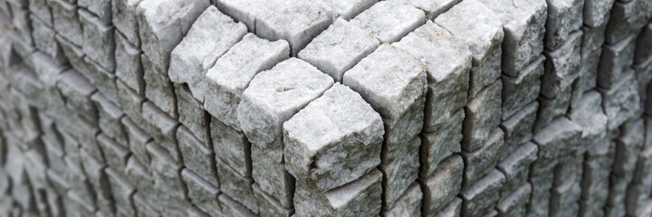Corner of the concrete cuboid made of gray uneven stones