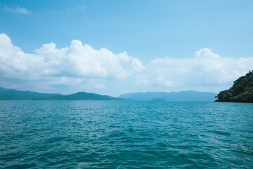 Clear water on the island,Bright blue sea and wooden boat The tourism