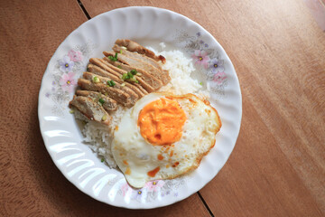 Pork fried garlic with rice and fried egg.
