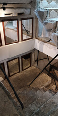 The cement stairs in the old building are decorated with mirrors.