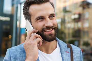 Young urban businessman on smart phone