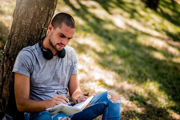 Man studying in the city park during the weekend