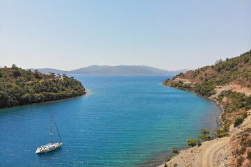 Fototapeta premium Beautiful yacht in a bay in the mountains, Aerial View