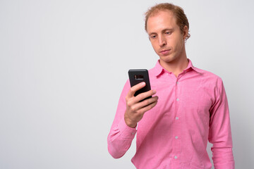 Portrait of businessman with blond hair using phone