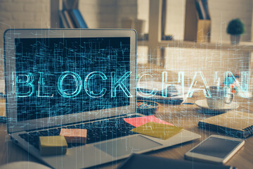 Multi exposure of blockchain theme hologram and table with computer background. Concept of bitcoin...