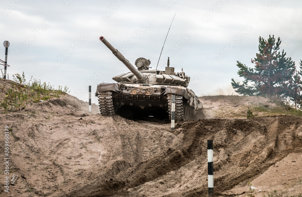 Wall mural battle tank performs driving exercises for military equipment at the tankodrome