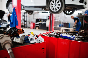 Car repair and maintenance theme. Mechanic in uniform working in auto service.