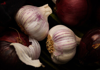 Low key photo of garlic and red onion