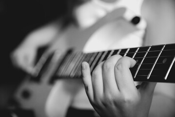 The musician's hands are holding an electric guitar. - 369669308