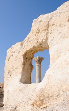 Well preserved carved column seen through the stone window at the Neolithic period Kourion Ancient city on the southwestern coast of Cyprus