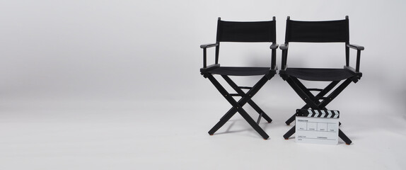 Two black director chair and clapper board use in video production or movie and cinema industry on white background.