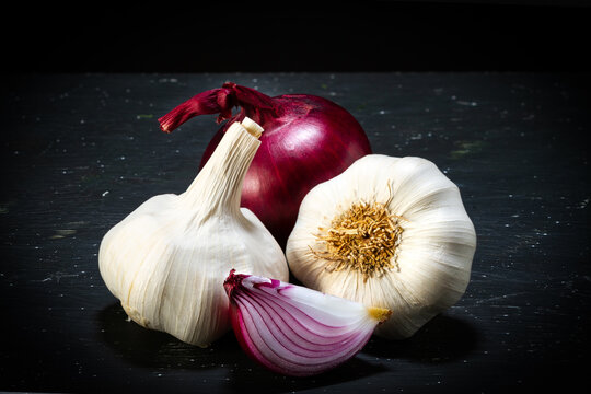 Red onion and garlic close-up on a black background. Food photography.