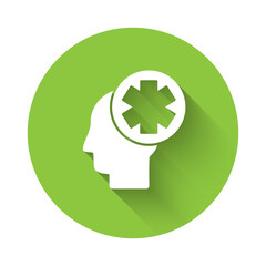 White Male head with hospital icon isolated with long shadow. Head with mental health, healthcare and medical sign. Green circle button. Vector Illustration.