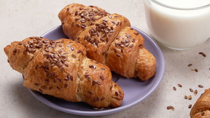 Fresh croissants on a rustic wooden background. Selective focus, horizontal.
