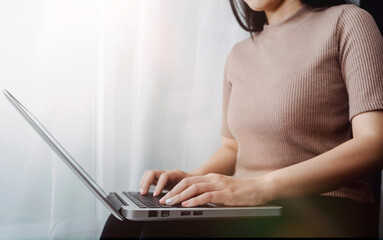 Naklejka premium businesswoman hand using smart phone, tablet payments and holding credit card online shopping, omni channel, digital tablet docking keyboard computer at office in sun light