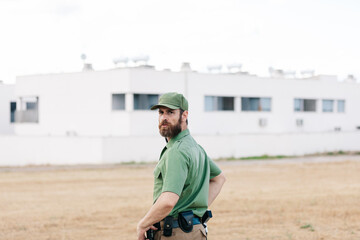 Fototapeta premium white man with security-watching beard controlling population areas and manufacturing