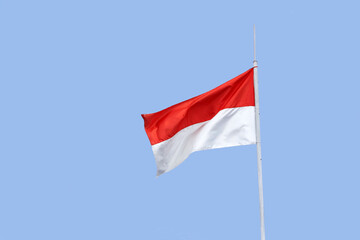 Fototapeta na wymiar Indonesian flag isolated on blue background.