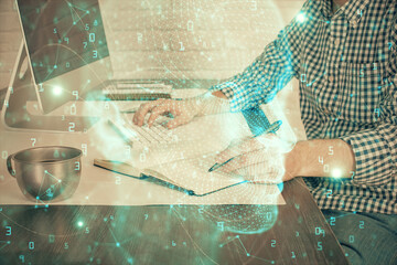 Man typing on keyboard background with brain hologram. Concept of big Data. Double exposure.