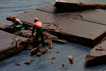 Piece of dark chocolate cut up by some workers