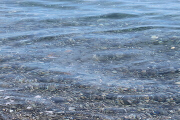 The crest of the sea wave. White foam waves on the sea surface. Rushing water in the sea