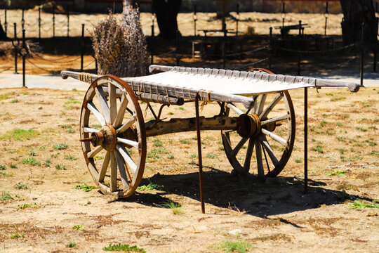 An old covered wagon wheel.
Traditional wooden tumbrel