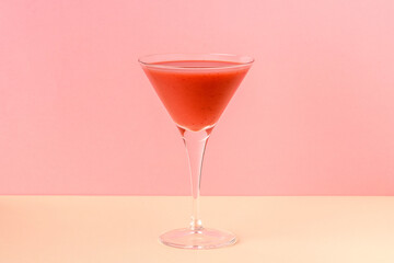 Strawberry smoothie cup on a pink and yellow background