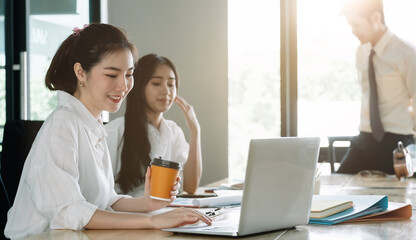 Young asian business people working with documents together at modern office