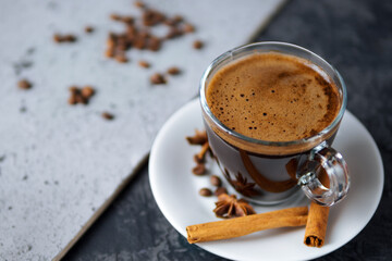 Cup of fragrant espresso with cinnamon close up