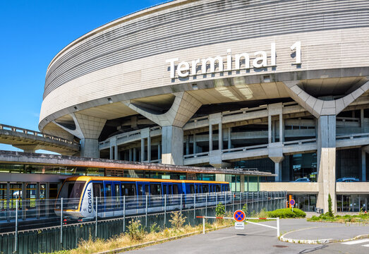 Roissy-en-France, France - July 27, 2020: A CDGVAL airport shuttle is stationing at the terminus station at the foot of the Terminal 1 circular concrete building of Paris-Charles de Gaulle Airport.