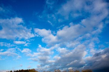 Blue sky with large clouds and sunlight. Nature background.