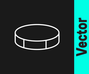 White line Hockey puck icon isolated on black background. Sport equipment. Vector Illustration.