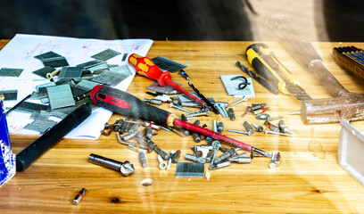 desktop in the workshop, tools lie on the table in the workshop. workshop table behind glass