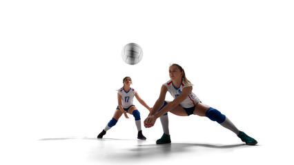 Female professional volleyball players in action on white background.