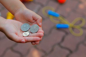 image of children hand coin 