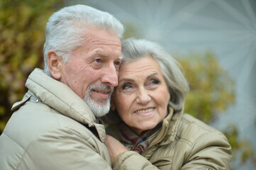 Portrait of smiling senior couple in autumn park