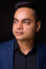 Obraz premium Portrait of young handsome Indian businessman in suit