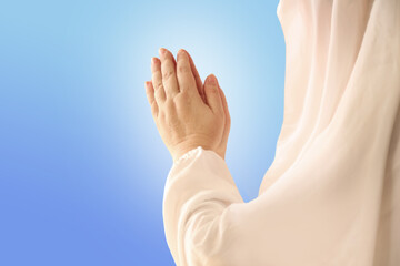 Plakat female hands, women in a white cloak raised palms with a prayer to God, the concept of prayers, sins, remorse, guilt, requests