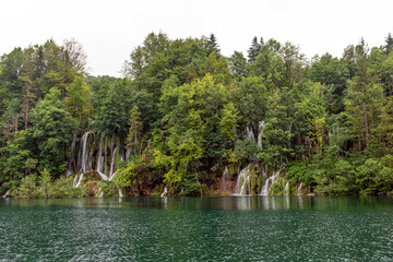 Beautiful waterfall and blue limpid lake in Plitvice Lakes National Park, Croatia